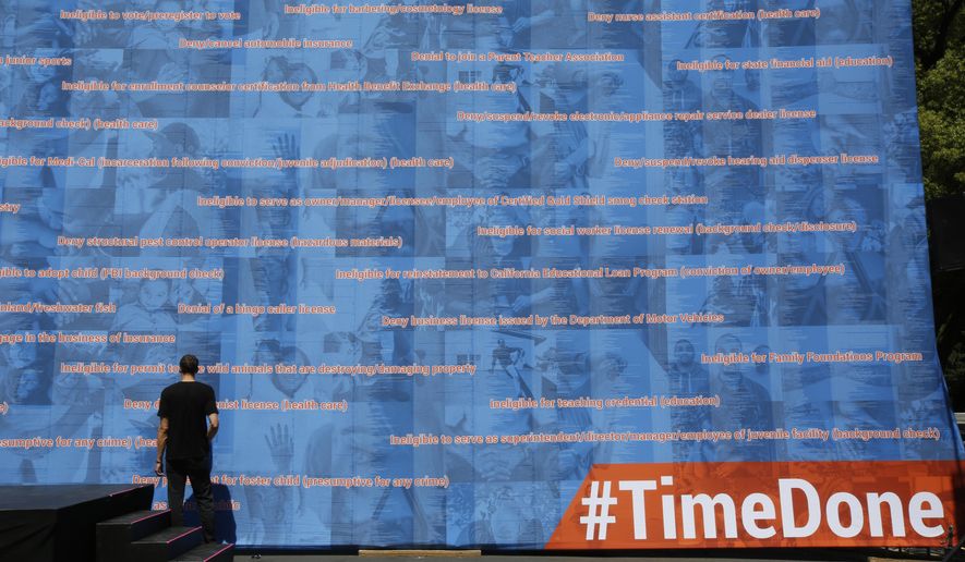 Part of 20-foot-tall, 70-foot-wide exhibit outlining legal restrictions that Americans with the past convictions or criminal records face after they've completed their sentences is displayed at a rally supporting legislation that would help automatically expunge old criminal records, in Sacramento, Calif., Tuesday June 11, 2019. The nonprofit organizer of the rally, Californians for Safety and Justice, estimates that 1 million Californians could benefit. (AP Photos by Rich Pedroncelli) in Sacramento, Calif., Tuesday June 11, 2019. (AP Photo/Rich Pedroncelli