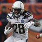 FILE - In this  Sunday, Dec. 30, 2018 file photo, Los Angeles Chargers running back Melvin Gordon rushes during the second half of an NFL football game against the Denver Broncos in Denver. Gordon is going into the final year of his contract. The fifth-year running back said after practice that he didn’t want to miss any practices but also didn’t rule out not being here when the team conducts its first training camp practice, Tuesday, June 11, 2019 . (AP Photo/David Zalubowski) ** FILE **
