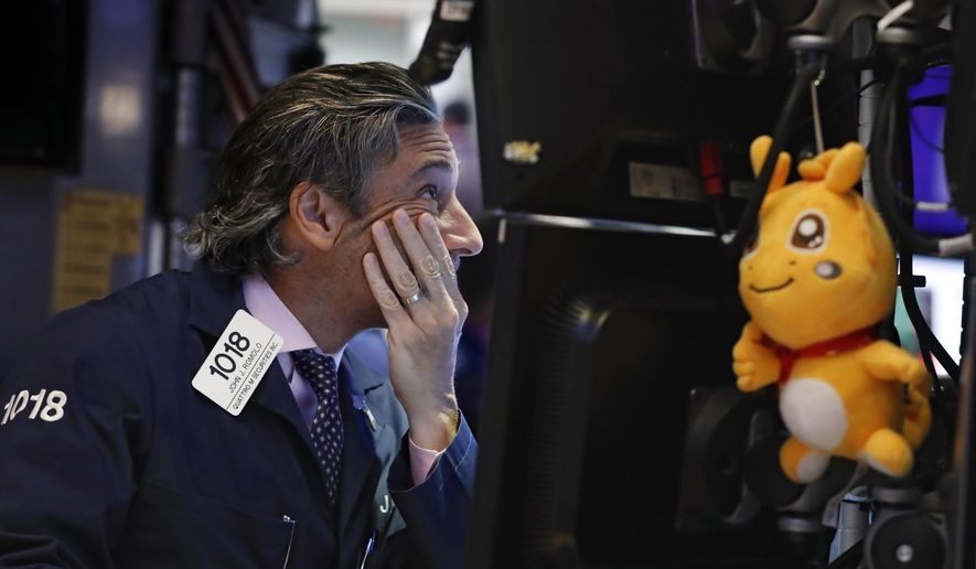 FILE - In this May 29, 2019, file photo trader John Romolo works on the floor of the New York Stock Exchange. It may seem like the market should take off once all the trade-war worries dissipate. But investors have a long list of worries that have nothing to do with tariffs. Not only are profit margins weakening, reports showed weakening economic trends around the world for April, which was before President Trump shattered the market’s calm with his tariff tweets. (AP Photo/Richard Drew, File)