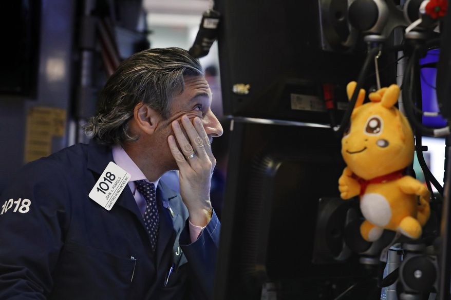FILE - In this May 29, 2019, file photo trader John Romolo works on the floor of the New York Stock Exchange. It may seem like the market should take off once all the trade-war worries dissipate. But investors have a long list of worries that have nothing to do with tariffs. Not only are profit margins weakening, reports showed weakening economic trends around the world for April, which was before President Trump shattered the market’s calm with his tariff tweets. (AP Photo/Richard Drew, File)