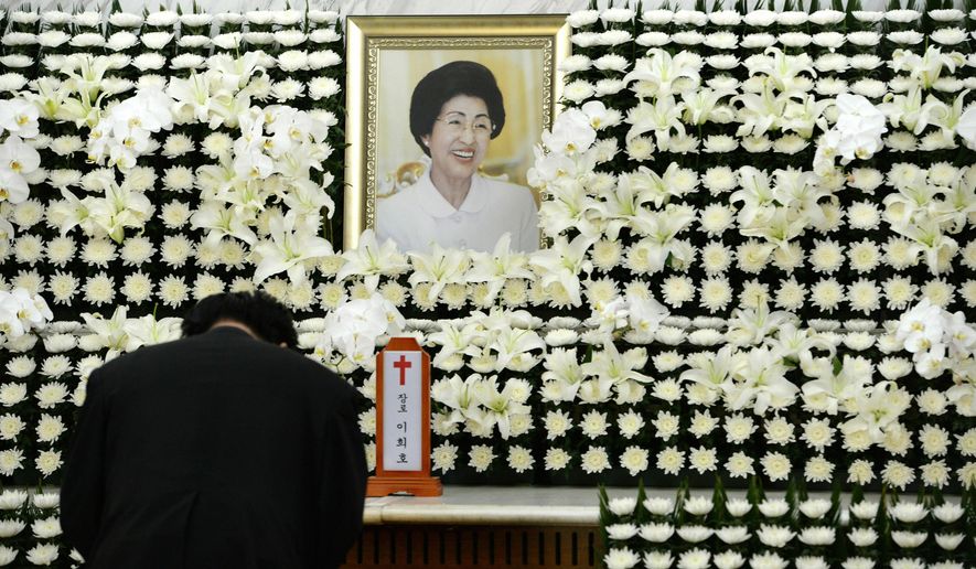 A mourner pays tribute at a memorial altar for the deceased Lee Hee-ho, a wife of the late former South Korean President Kim Dae-jung, at a hospital in Seoul, South Korea, Tuesday, June 11, 2019. Lee, a South Korean feminist activist who fought for democracy against dictatorships alongside her husband and future President Kim, has died. She was 96.(Ahn Jung-won/Yonhap via AP)