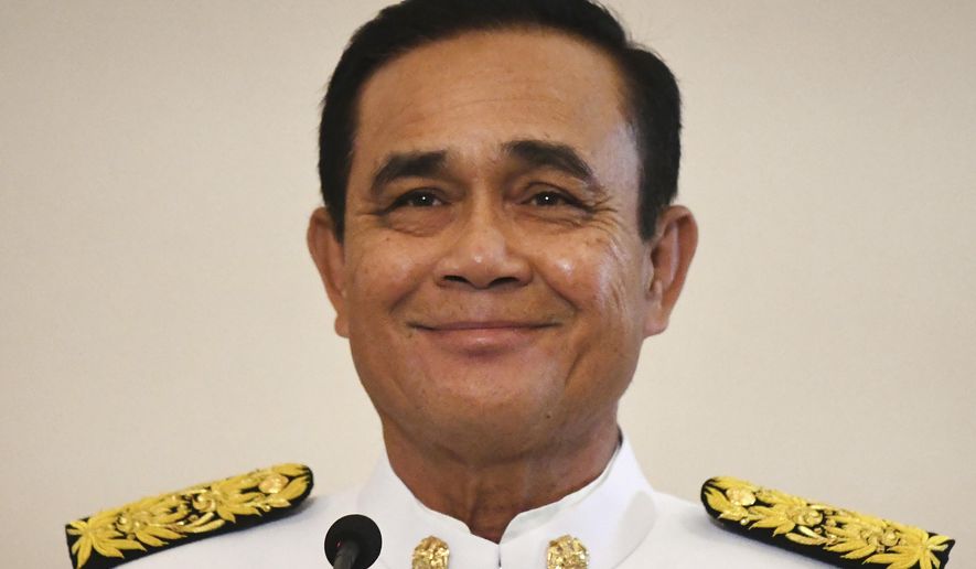 Thailand's junta leader Prayut Chan-oha smiles after the royal endorsement ceremony at the Government House, Tuesday, June 11, 2019, in Bangkok, Thailand. Prayuth has been officially proclaimed prime minister after the king endorsed Parliament's vote to allow him to keep the position. (Lillian Suwanrumpha/Pool Photo via AP)