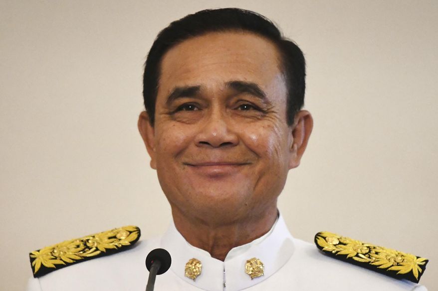 Thailand's junta leader Prayut Chan-oha smiles after the royal endorsement ceremony at the Government House, Tuesday, June 11, 2019, in Bangkok, Thailand. Prayuth has been officially proclaimed prime minister after the king endorsed Parliament's vote to allow him to keep the position. (Lillian Suwanrumpha/Pool Photo via AP)