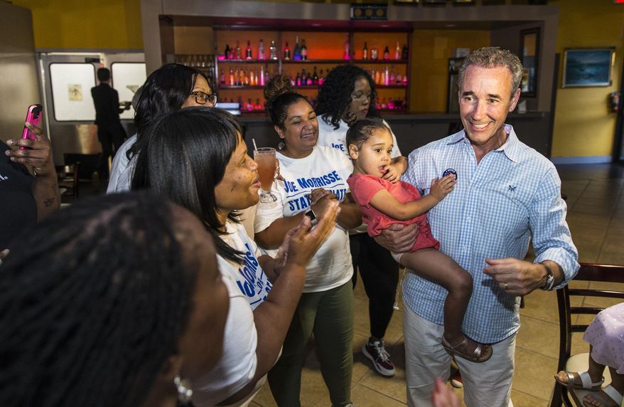 Joe Morrissey, right, with his daughter Bella, 3, celebrates his Democratic primary win in 16th District State Senate race with his supporters at the election party of Plaza Mexico in Petersburg, Va., Tuesday, June 11, 2019. (Daniel Sangjib Min/Richmond Times-Dispatch via AP)