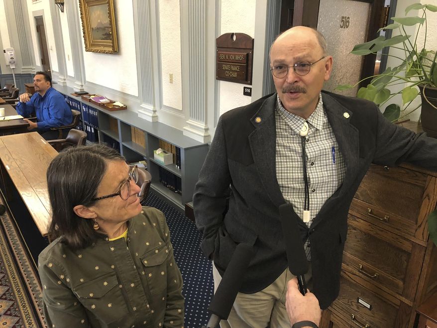 Alaska state Sen. Click Bishop, right, speaks to reporters as Rep. Jennifer Johnston listens in Juneau, Alaska Wednesday, June 12, 2019. Bishop and Johnston are leading a working group tasked with making recommendations on the future use of earnings from the state's oil-wealth fund, the Alaska Permanent Fund. (AP Photo/Becky Bohrer)