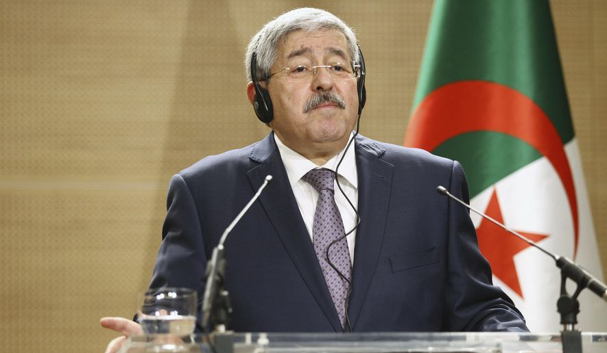 FILE - In this Monday, Sept. 17, 2018 file photo, Algerian Prime Minister Ahmed Ouyahia listens to a question during a press conference in Algiers, Algeria. Former Algerian Prime Minister Ahmed Ouyahia has been imprisoned by a Supreme Court judge investigating corruption, taken in a police van to a prison on the outskirts of the capital. Numerous journalists saw the van leave the Supreme Court on Wednesday, June 12, 2019 for the prison of El Harrach after an hours-long appearance before the investigating judge. (AP Photo/Anis Belghoul, file)