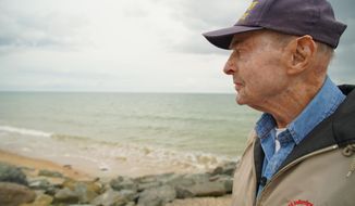 D-Day survivor Ray Lambert looks out over Omaha Beach in Colleville-sur-Mer, France, on Wednesday, June 5, 2019. The North Carolina man was wounded four times on the beach during the Normandy invasion 75 years ago. (AP Photo/Allen G. Breed)