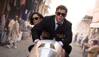 This image released by Sony Pictures shows Chris Hemsworth, foreground, and Tessa Thompson in a scene from Columbia Pictures&#39; &amp;quot;Men in Black: International.&amp;quot; (Giles Keyte/Sony/Columbia Pictures via AP)