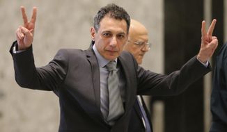 Nizar Zakka, a Lebanese citizen and U.S. permanent resident, who was released in Tehran after nearly four years in jail on charges of spying, flashes victory signs upon his arrival at the presidential palace, in Baabda, east of Beirut, Tuesday, June 11, 2019. Zakka a Lebanese businessman was allowed to fly to Lebanon, a development that comes amid heightened tensions between Iran and the U.S. after President Donald Trump withdrew America from Tehran&#39;s nuclear deal with world powers. (AP Photo/Hussein Malla)