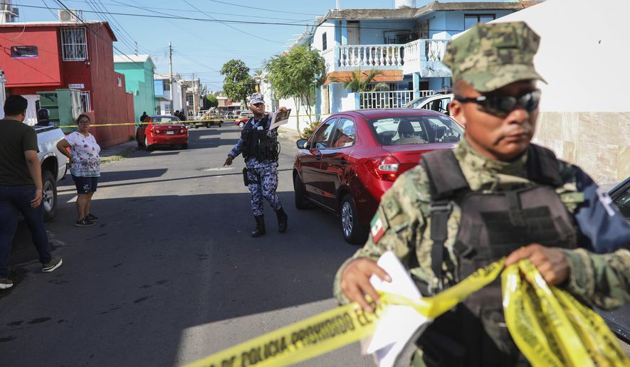 Authorities cordon off the area where journalist Marcos Miranda was kidnapped, in Boca del Rio, Veracruz state, Mexico, Wednesday, June 12, 2019. Miranda was abducted this morning from his home by armed men, according to the Network of Veracruz Journalists. (AP Photo/Felix Marquez)
