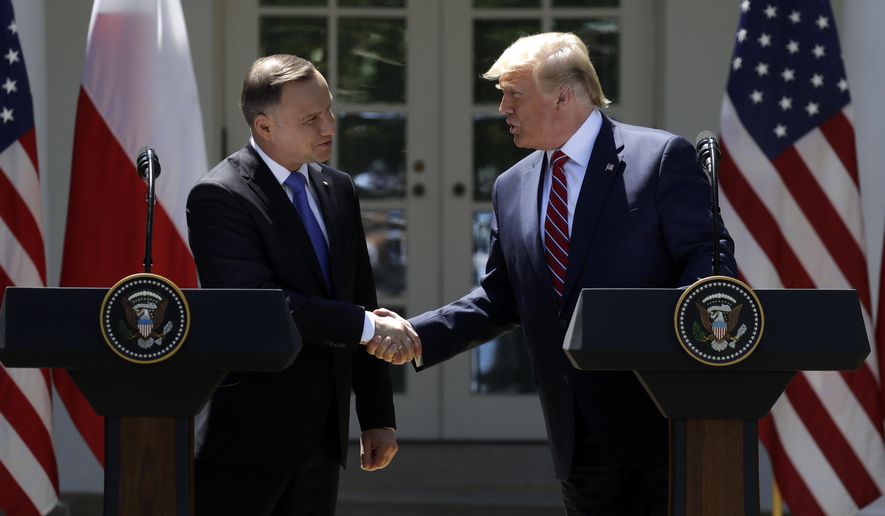President Donald Trump shakes hands with Polish President Andrzej Duda during a news conference in the Rose Garden of the White House, Wednesday, June 12, 2019, in Washington. (AP Photo/Evan Vucci)