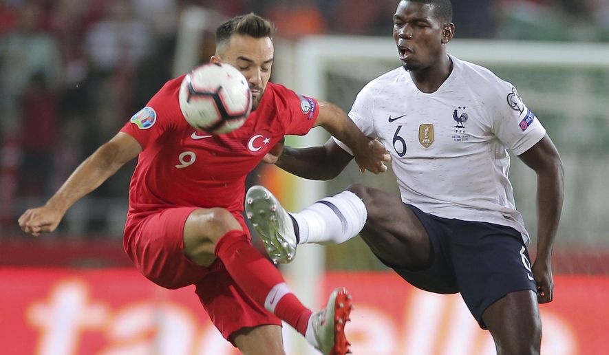 Turkey&#39;s forward Kenan Karaman, left, is challenged by France&#39;s midfielder Paul Pogba during the Euro 2020 Group H qualifying soccer match between Turkey and France in Konya, Turkey, Saturday June 8, 2019. (AP Photo)