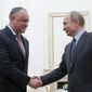 Russian President Vladimir Putin, right, shakes hands with his Moldovan counterpart Igor Dodon during a meeting at the Kremlin in Moscow, Russia, Wednesday, Jan. 30, 2019. (Maxim Shemetov/Pool Photo via AP) **FILE**