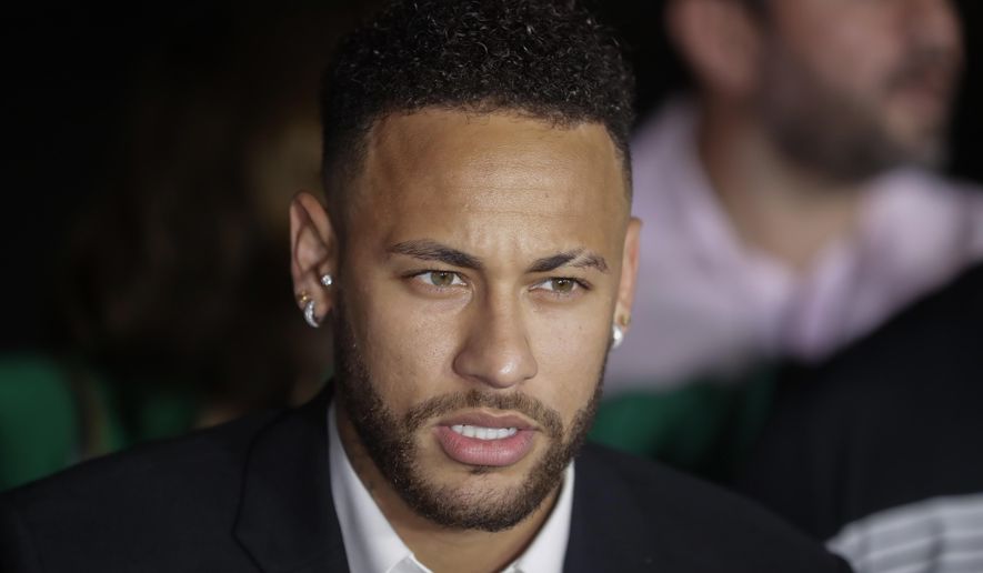Brazil's soccer player Neymar speaks to the press as he leaves a police station where he answered questions about rape allegations against him in Sao Paulo, Brazil, Thursday, June 13, 2019. Neymar denies any wrongdoing. (AP Photo/Andre Penner)