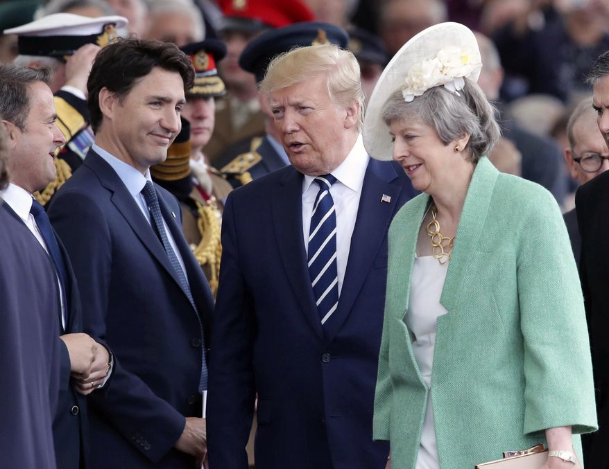Canadian Prime Minister Justin Trudeau, US President Donald Trump and Britain's Prime Minister Theresa May attend commemorations for the 75th Anniversary of the D-Day landings in Portsmouth, England, Wednesday June 5, 2019. Commemoration events are marking the 75th Anniversary of the D-Day landings when Allied forces stormed the beaches of Normandy in northern France during World War II. (Andrew Matthews/PA via AP)