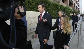 In this Dec. 3, 2018 file photo, Republican Rep. Duncan Hunter, center, leaves court in San Diego. The wife of U.S. Rep. Duncan Hunter pleaded guilty Thursday, June 13, 2019 to a single corruption count and agreed to testify against her husband at his trial on charges the couple spent more than $200,000 in campaign funds on trips, dinners, clothes and other personal expenses.  (AP Photo/Gregory Bull,File) **FILE**