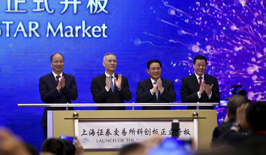 From left; Yi Huiman, Chairman of China Securities Regulatory Commission, Chinese Vice Premier Liu He, Shanghai Party Secretary Li Qiang, Shanghai mayor and Ying Yong applaud during a ceremony for the launch of the SSE STAR Market, previously referred to as the Shanghai Science and Technology Innovation Board, in Shanghai, Thursday, June 13, 2019. Chinese media say the country's top trade negotiator has told a forum in Shanghai that "external pressures" can help the economy. (Chinatopix via AP)
