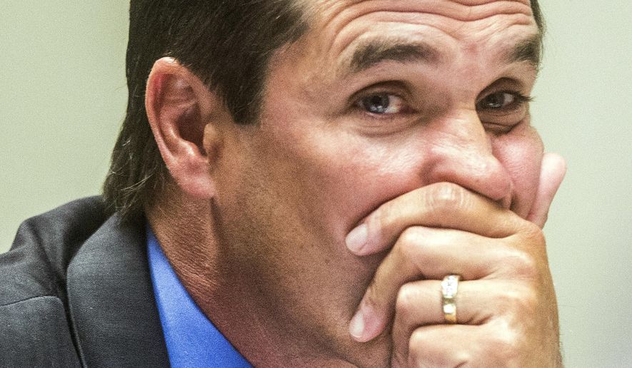 FILE - In this July 25, 2018, file photo, Nick Lyon, Michigan's Department of Health and Human Services director, looks to the judge during Lyon's preliminary examination in Genesee District Court in Flint, Mich. Prosecutors say they're dismissing all criminal charges against eight people in the Flint water scandal and starting the investigation over again. The eight people include former Michigan health director Nick Lyon. He was accused of failing to timely inform the public about an outbreak of Legionnaires' disease when Flint was using improperly treated water from the Flint River in 2014 and 2015. The outbreak occurred at the same time that the city's water system was contaminated with lead. Lyon was the highest-ranking official to be charged in the investigation. (Jake May/The Flint Journal via AP, File)