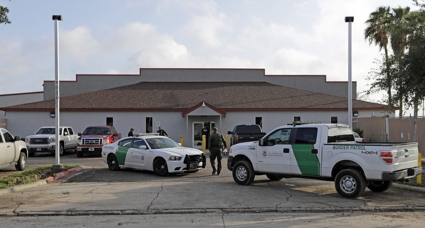 FILE - In this Saturday, June 23, 2018, file photo, a U.S. Border Patrol Agent walks between vehicles outside the Central Processing Center in McAllen, Texas. Advocates were shocked to find an underage mom and her tiny, premature newborn daughter huddled in a Border Patrol facility the second week of June 2019, in what they say was another example of the poor treatment immigrant families receive after crossing the border. The mother is a Guatemalan teen who crossed the border without a parent and was held at a facility in McAllen, Texas, with other families with children. (AP Photo/David J. Phillip, File)