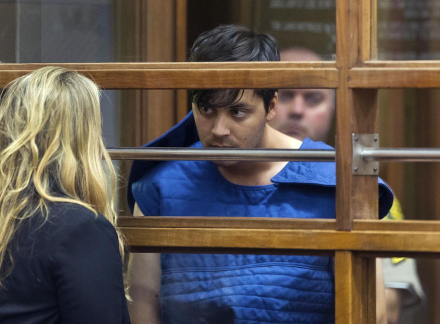 Suspect Rhett McKenzie Nelson talks to an attorney as he appears in Los Angeles Superior court, Thursday, June 13, 2019 in Los Angeles. Nelson has been charged with murder in the deaths of an off-duty Los Angeles County sheriff's deputy and another man. (AP Photo/Damian Dovarganes)