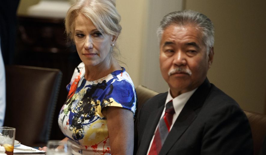 White House counselor Kellyanne Conway, left, and Hawaii Gov. David Ige listen as President Donald Trump speaks during a meeting with governors on "workforce freedom and mobility" in the Cabinet Room of the White House, Thursday, June 13, 2019, in Washington. (AP Photo/Evan Vucci)