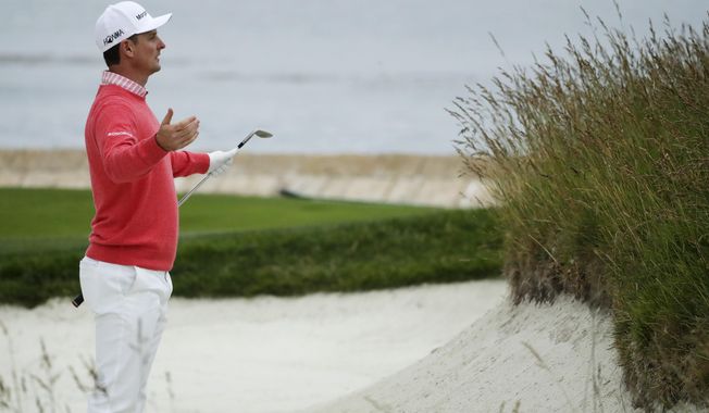 Justin Rose, of England, reacts to his bunker shot on the 18th hole during the first round of the U.S. Open Championship golf tournament Thursday, June 13, 2019, in Pebble Beach, Calif. (AP Photo/Matt York)