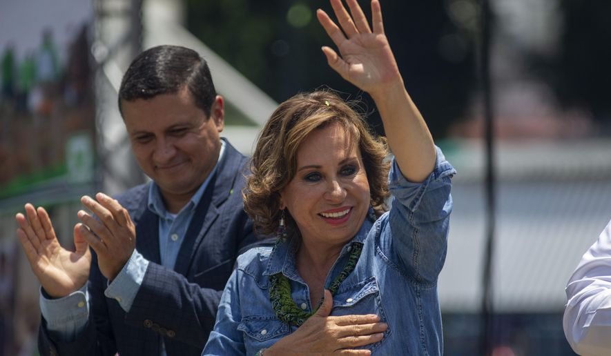 Sandra Torres, presidential candidate of the National Unity of Hope party, UNE, waves to supporters during her closing campaign rally prior to Sunday's general elections, in Villanueva, Guatemala, Friday, June 14, 2019. (AP Photo/Moises Castillo)