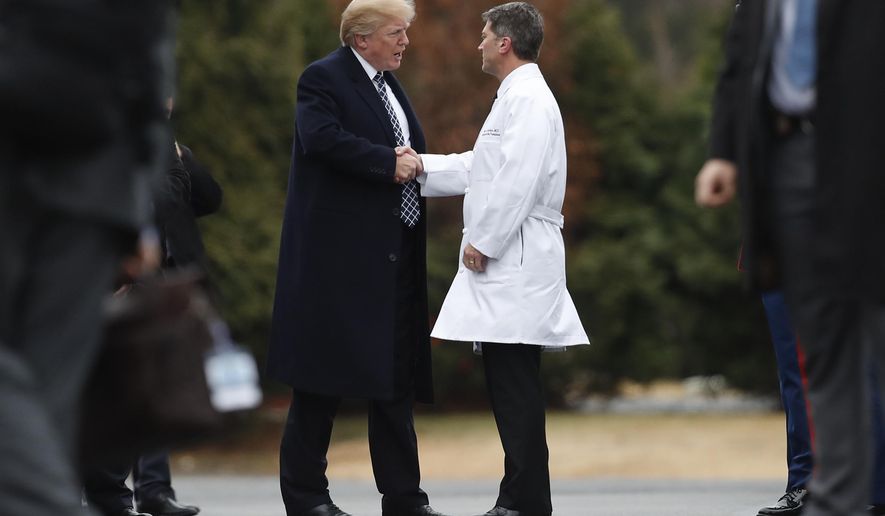 In this Friday, Jan. 12, 2018, file photo, President Donald Trump shakes hands with then-White House physician Dr. Ronny Jackson as he boards Marine One to leave Walter Reed National Military Medical Center in Bethesda, Md., after his first medical check-up as president. On June 3, 2020, the White House said Mr. Trump has completed his annual physical. (AP Photo/Carolyn Kaster) ** FILE **