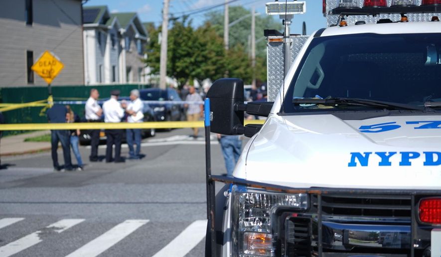 New York City Police officials gather along Wilcox Street behind the 121st Precinct station house following a report of a police officer shot in the Staten Island borough of New York, Friday, June 14, 2019. The officer's condition wasn't immediately known. (Joseph Ostapiuk/Staten Island Advance via AP)