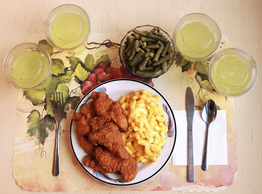 This undated photo provided by the National Institutes of Health in June 2019 shows an "ultra-processed" lunch including brand-name macaroni and cheese, chicken tenders, canned green beans and diet lemonade. Researchers found people ate an average of 500 extra calories a day when fed mostly processed foods, compared with when the same people were fed minimally processed foods. That’s even though researchers tried to match the meals for nutrients like fat, fiber and sugar. (Paule Joseph, Shavonne Pocock/NIH via AP) **FILE**