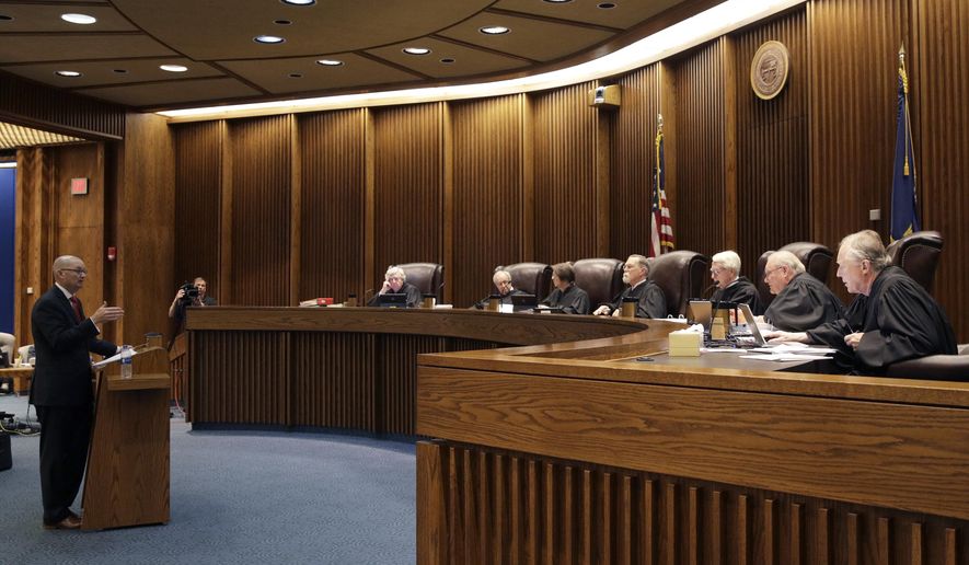 FILE - In this May 9, 2019 photo, State of Kansas attorney Toby Crouse, left, presents his case before the Kansas Supreme Court during oral arguments in a school funding case in Topeka, Kan. Kansas&#x27; highest court has signed off on an increase in spending on public schools that the Democratic governor pushed through the Republican-controlled Legislature. But the justices declined in their ruling Friday to close the protracted education funding lawsuit that prompted their decision. The school finance law boosted funding roughly $90 million a year. The court said it wants to ensure that the state keeps its funding promises. (AP Photo/Charlie Riedel, File)
