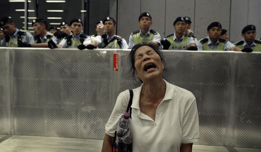 In this Monday, June 10, 2019, file photo, a protester reacts as police officers clash with protesters in a rally against the proposed amendments to the extradition law at the Legislative Council in Hong Kong during the early hours. The extradition law has aroused concerns that this legislation would undermine the city's independent judicial system as it allows Hong Kong to hand over fugitives to the jurisdictions that the city doesn't currently have an extradition agreement with, including mainland China, where a fair trial might not be guaranteed. (AP Photo/Vincent Yu, File)