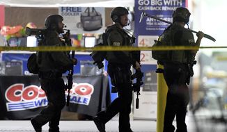 Heavily armed police officers exit the Costco following a shooting inside the wholesale warehouse in Corona, Calif.,  Friday, June 14, 2019.  A gunman opened fire inside the store during an argument,  killing a man, wounding two other people and sparking a stampede of terrified shoppers before he was taken into custody, police said. The man involved in the argument was killed and two other people were wounded, Corona police Lt. Jeff Edwards said.  (Will Lester/Inland Valley Daily Bulletin/SCNG via AP)