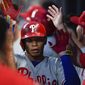 Philadelphia Phillies second baseman Cesar Hernandez is congratulated in the dugout after hitting a home run during the fourth inning of a baseball game against the Atlanta Braves, Saturday, June 15, 2019, in Atlanta. (AP Photo/John Amis)