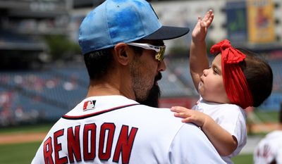 The Nationals&#39; Anthony Rendon holds his 10-month-old daughter Emma on the field before Sunday&#39;s game. (Associated Press)