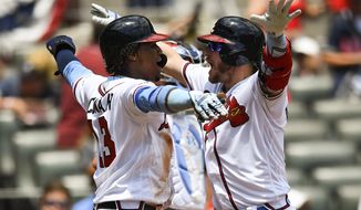 Atlanta Braves&#39; Josh Donaldson, right, celebrates his two-run home run with Ronald Acuna Jr., left, at home plate during the third inning of a baseball game against the Philadelphia Phillies, Sunday, June 16, 2019, in Atlanta. (AP Photo/John Amis)