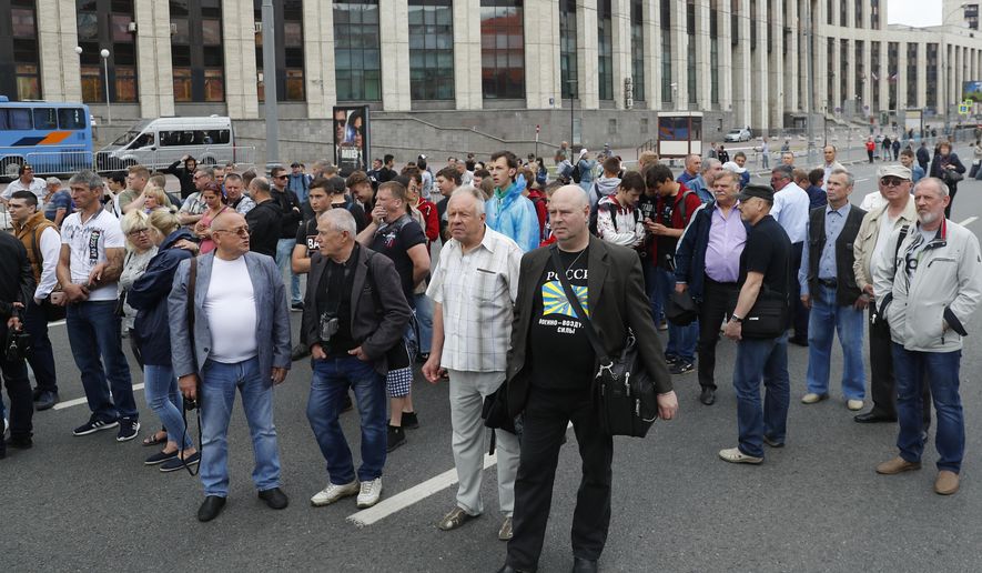 Demonstrators gather to attend a rally titled "Law and justice for all" in support of all journalists in Moscow, Russia, Sunday, June 16, 2019. (AP Photo/Pavel Golovkin)