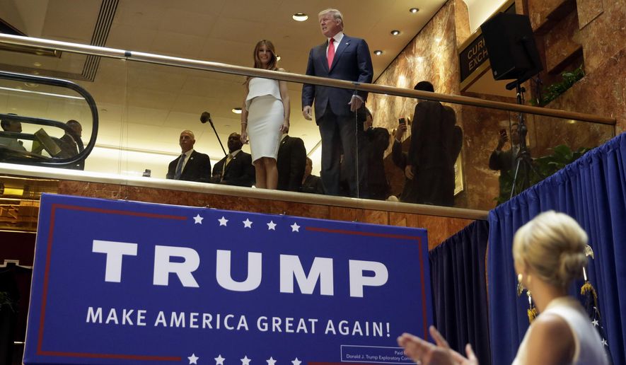 In this Sunday, June 16, 2015, file photo, Donald Trump, accompanied by his wife Melania Trump, is applauded by his daughter Ivanka Trump, right as he&#x27;s introduced before his announcement that he will run for president in the lobby of Trump Tower in New York. It was the escalator ride that would change history.  (AP Photo/Richard Drew, File) **FILE**