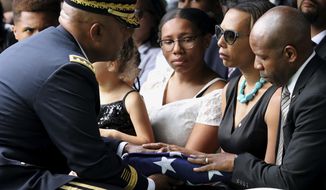 The folded American Flag is presented to West Point Cadet Christopher J. Morgan&#39;s parents, April and Christopher by Superintendent Darryl Williams, during the interment ceremony at West Point, N.Y., Saturday, June 15, 2019. Over 1500 family, friends and military personnel attended, as well as former President Bill Clinton who delivered remarks at the memorial service. (Mark Vergari/The Journal News via AP)