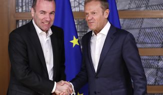 European People&#39;s Party member and Candidate for the next president of the European Commission, Germany&#39;s Manfred Weber, left, is welcomed by European Council President Donald Tusk ahead to a meeting on EU top jobs at the Europa building in Brussels, Thursday, June 13, 2019. (Olivier Hoslet, Pool Photo via AP)
