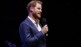 Britain&#39;s Prince Harry speaks on stage during a concert hosted by his charity Sentebale at Hampton Court Palace, in London, Tuesday June 11, 2019. The concert will raise funds and awareness for Sentebale, the charity founded by Prince Harry and Lesotho&#39;s Prince Seeiso in 2006, to support children and young people affected by HIV and AIDS in Lesotho, Botswana and Malawi. (AP Photo/Matt Dunham, Pool)