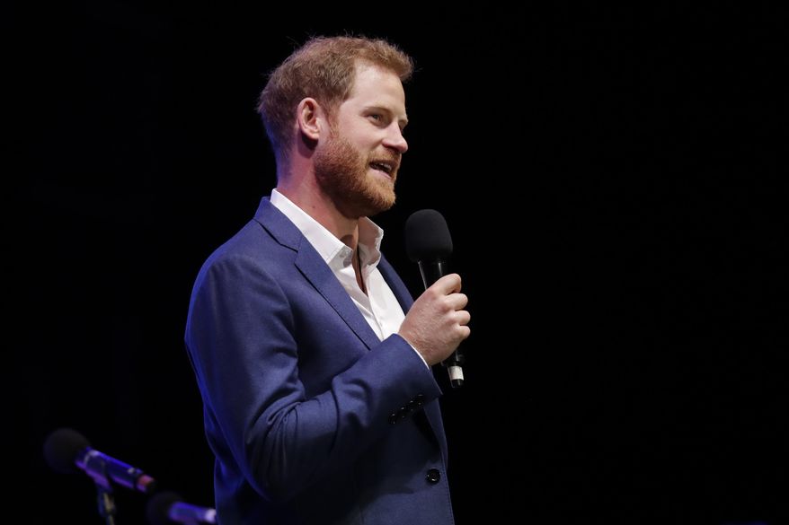 Britain&#39;s Prince Harry speaks on stage during a concert hosted by his charity Sentebale at Hampton Court Palace, in London, Tuesday June 11, 2019. The concert will raise funds and awareness for Sentebale, the charity founded by Prince Harry and Lesotho&#39;s Prince Seeiso in 2006, to support children and young people affected by HIV and AIDS in Lesotho, Botswana and Malawi. (AP Photo/Matt Dunham, Pool)