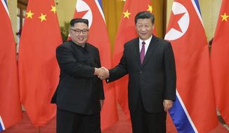 In this June 19, 2018, file photo released by China&#39;s Xinhua News Agency, Chinese President Xi Jinping, right, poses with North Korean leader Kim Jong-un for a photo during a welcome ceremony at the Great Hall of the People in Beijing. Chinese state media say Xi will make a state visit to North Korea this week. State broadcaster CCTV said in its evening news program on Monday that Xi will meet with North Korean leader Kim during a visit Thursday and Friday. (Ju Peng/Xinhua via AP, File)