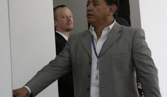 FILE - In this May 2, 2019 file photo, Swedish programmer Ola Bini, left back, arrives for a court hearing in which his lawyers are requesting his freedom, in Quito, Ecuador. U.S. investigators have requested permission from Ecuador to question the Swedish programmer close to Julian Assange held in jail for more than two months on suspicion of hacking, the Associated Press has learned. The interview with Ola Bini is set to take place on Thursday,  June 27th. (AP Photo/Dolores Ochoa, File)