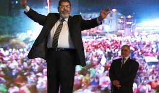 FILE - In this May 20, 2012 file photo, then Muslim Brotherhood&#x27;s presidential candidate Mohammed Morsi holds a rally in Cairo, Egypt. On Monday June 17, 2019, Egypt&#x27;s state TV says the country&#x27;s ousted President Mohammed Morsi, 67, collapsed during a court session and died. It said it occurred while he was attending a court trial on Monday on espionage charges. Morsi, who hailed from Egypt&#x27;s largest Islamist group, the now outlawed Muslim Brotherhood, was elected president in 2012 in the country&#x27;s first free elections following the ouster the year before of longtime leader Hosni Mubarak. (AP Photo/Fredrik Persson, File)