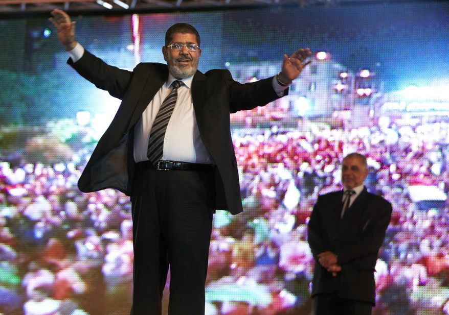 FILE - In this May 20, 2012 file photo, then Muslim Brotherhood&#39;s presidential candidate Mohammed Morsi holds a rally in Cairo, Egypt. On Monday June 17, 2019, Egypt&#39;s state TV says the country&#39;s ousted President Mohammed Morsi, 67, collapsed during a court session and died. It said it occurred while he was attending a court trial on Monday on espionage charges. Morsi, who hailed from Egypt&#39;s largest Islamist group, the now outlawed Muslim Brotherhood, was elected president in 2012 in the country&#39;s first free elections following the ouster the year before of longtime leader Hosni Mubarak. (AP Photo/Fredrik Persson, File)