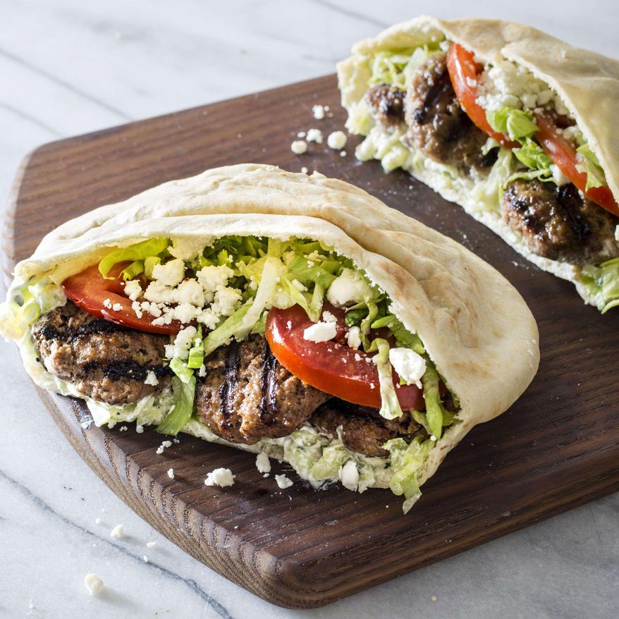 This undated photo provided by America's Test Kitchen in June 2019 shows a Grilled Greek-Style Lamb Pita in Brookline, Mass. This recipe appears in “The Complete Mediterranean Cookbook.” (Carl Tremblay/America's Test Kitchen via AP)