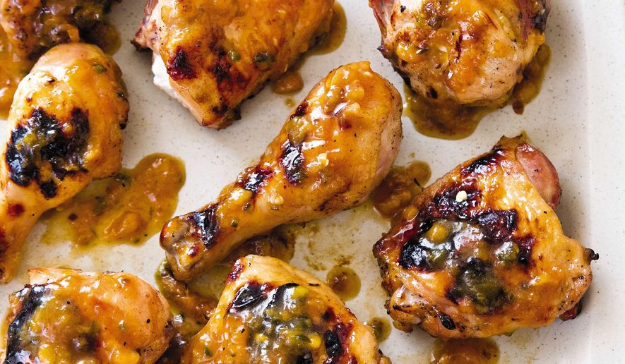 This undated photo provided by America's Test Kitchen in June 2019 shows Peach-Glazed Grilled Chicken in Brookline, Mass. This recipe appears in the cookbook "Master of the Grill." (Joe Keller/America's Test Kitchen via AP)