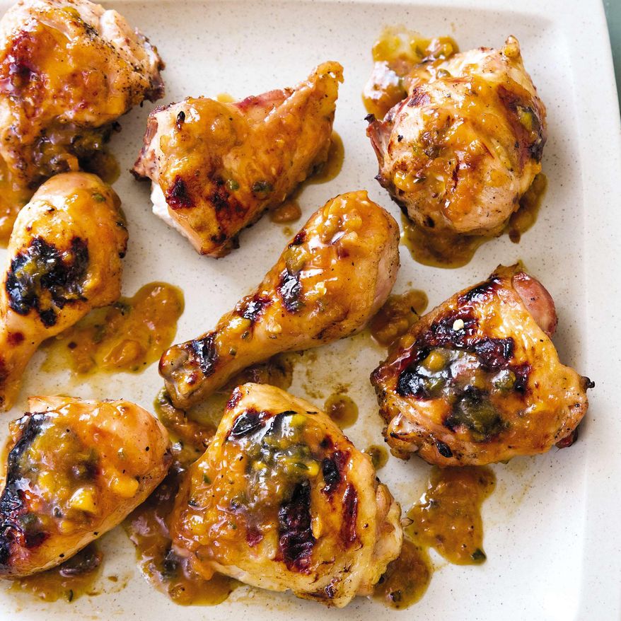This undated photo provided by America's Test Kitchen in June 2019 shows Peach-Glazed Grilled Chicken in Brookline, Mass. This recipe appears in the cookbook "Master of the Grill." (Joe Keller/America's Test Kitchen via AP)