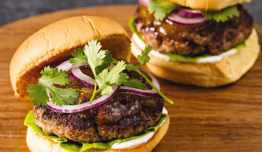 This undated photo provided by America's Test Kitchen in June 2019 shows Spiced Turkey Burgers with Mango Chutney in Brookline, Mass. This recipe appears in the cookbook “The Ultimate Burger.” (Daniel J. van Ackere/America's Test Kitchen via AP)